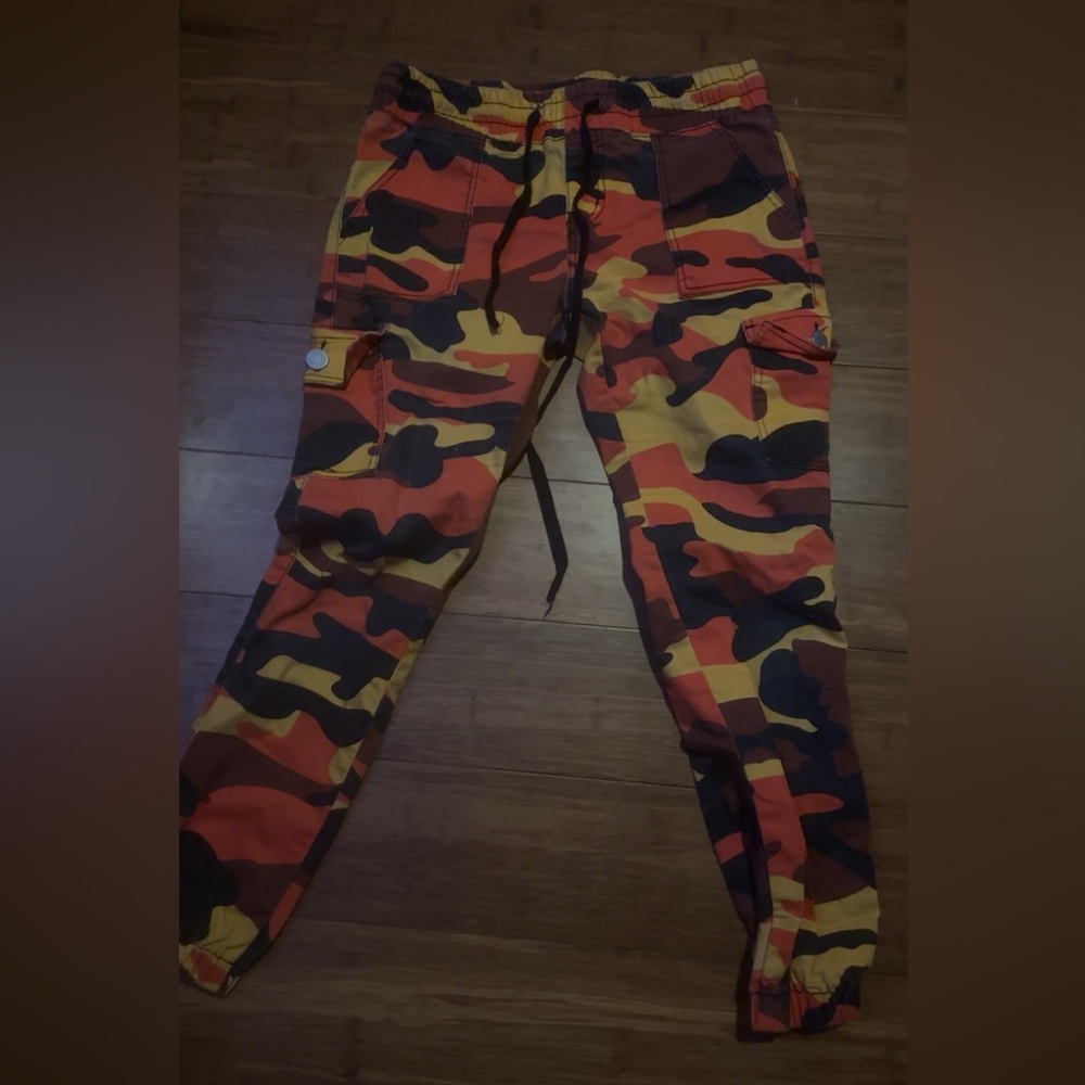 red, orange, black and brown camouflage jeans